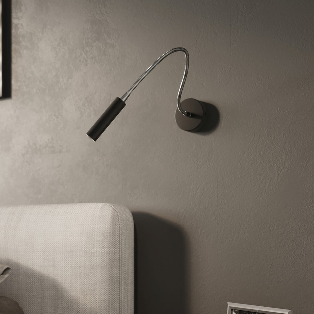 Applique Axil noire, bras flexible orienté vers un livre