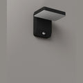 Applique extérieure Ladis éteinte sur un mur gris panneau plat au-dessus du boîtier noir et de son détecteur