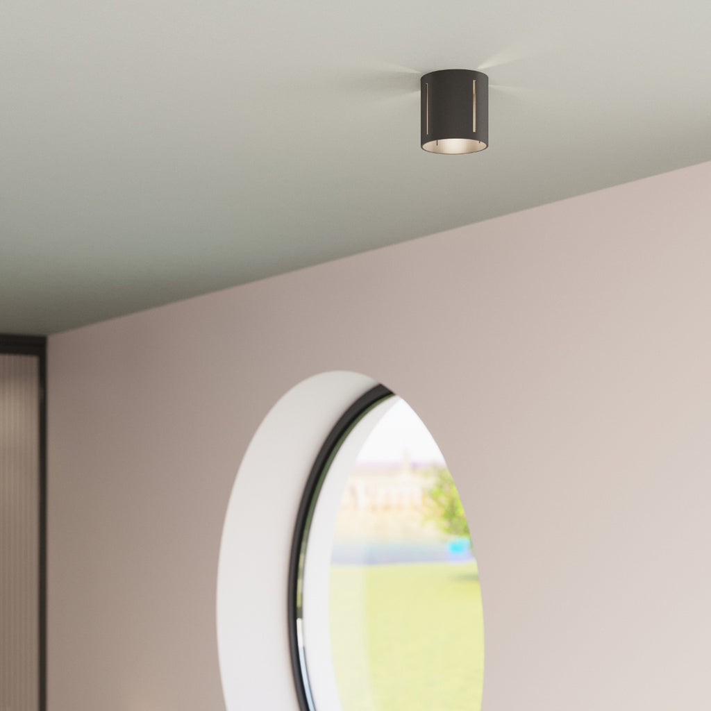 Applique Inez noire en situation, jeu de lumière sur le mur