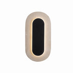 Applique murale Travertino de face cadre ovale de travertin beige autour d'une plaque ovale noire rétroéclairée