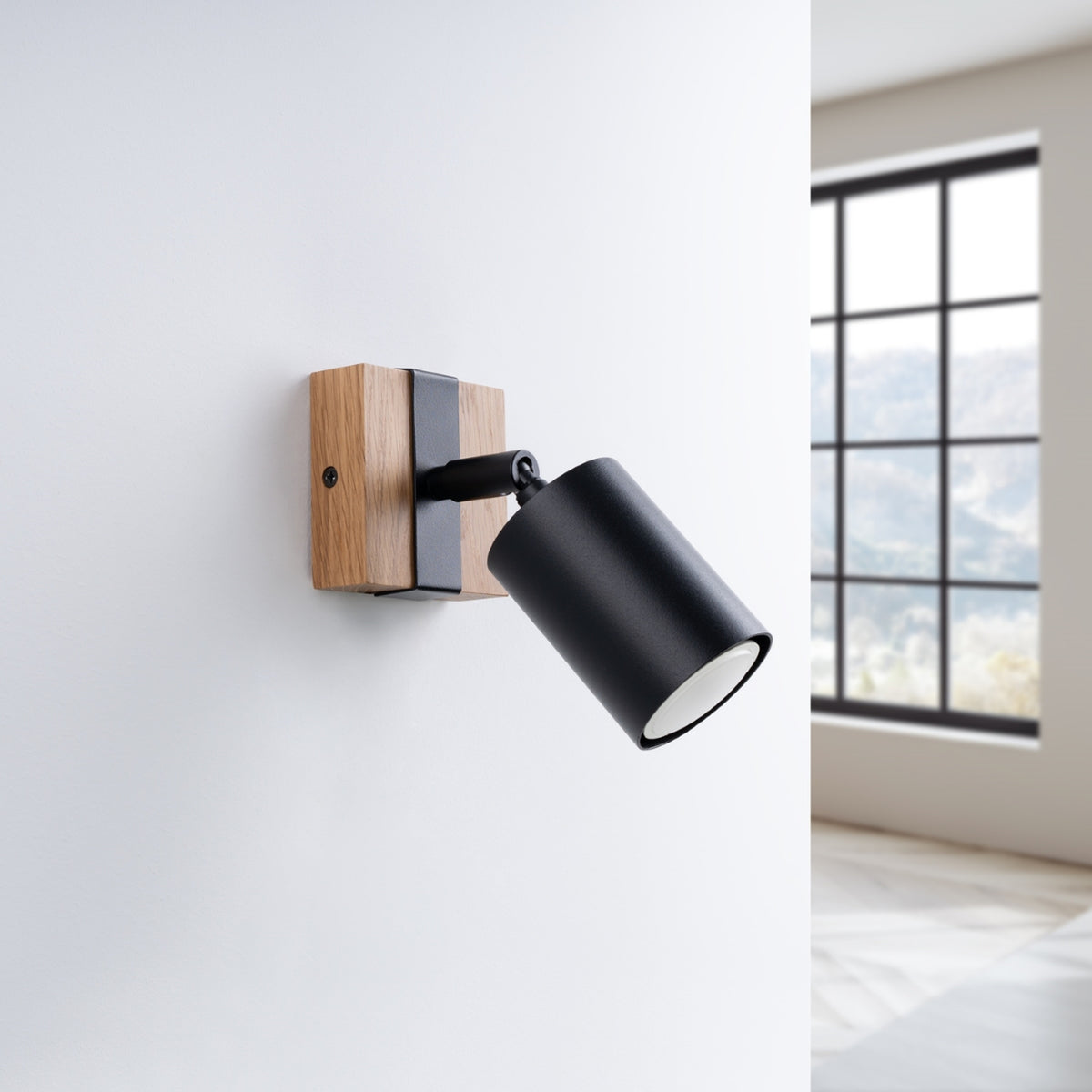 Applique Fager bois et acier noir fixée sur un mur blanc près d'une fenêtre