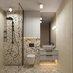 Salle de bain en terrazzo éclairée par le modèle Zori en céramique émaillée blanche au plafond et en applique près du miroir