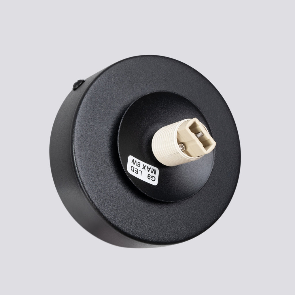 Applique Yoli 1 boule opale acier noire G9 dans un intérieur