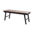 Banc pliant Herringbone en teck naturel vu de trois quarts avec ses pieds évasés en fer noir