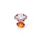Bougeoir facetté vu en plongée sur sa coupe hexagonale rose et son socle ambre