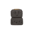 Bougeoir visage en pierre noire vu de face avec son godet en laiton et sa frise de triangles gravée