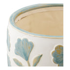 Détail du bord bleu et de l'intérieur beige mat du cache-pot en céramique floral