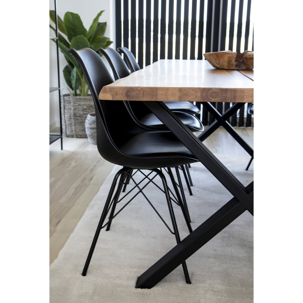 Dos des chaises Oslo noires autour d'une table en bois – salle à manger ouverte lumineuse