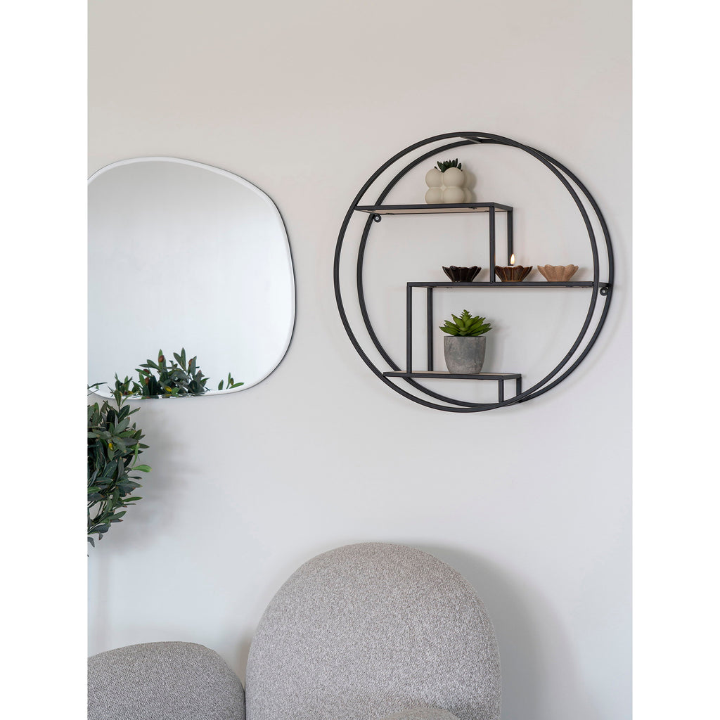 Étagère murale ronde Rotterdam en situation salon avec miroir rond et fauteuil gris