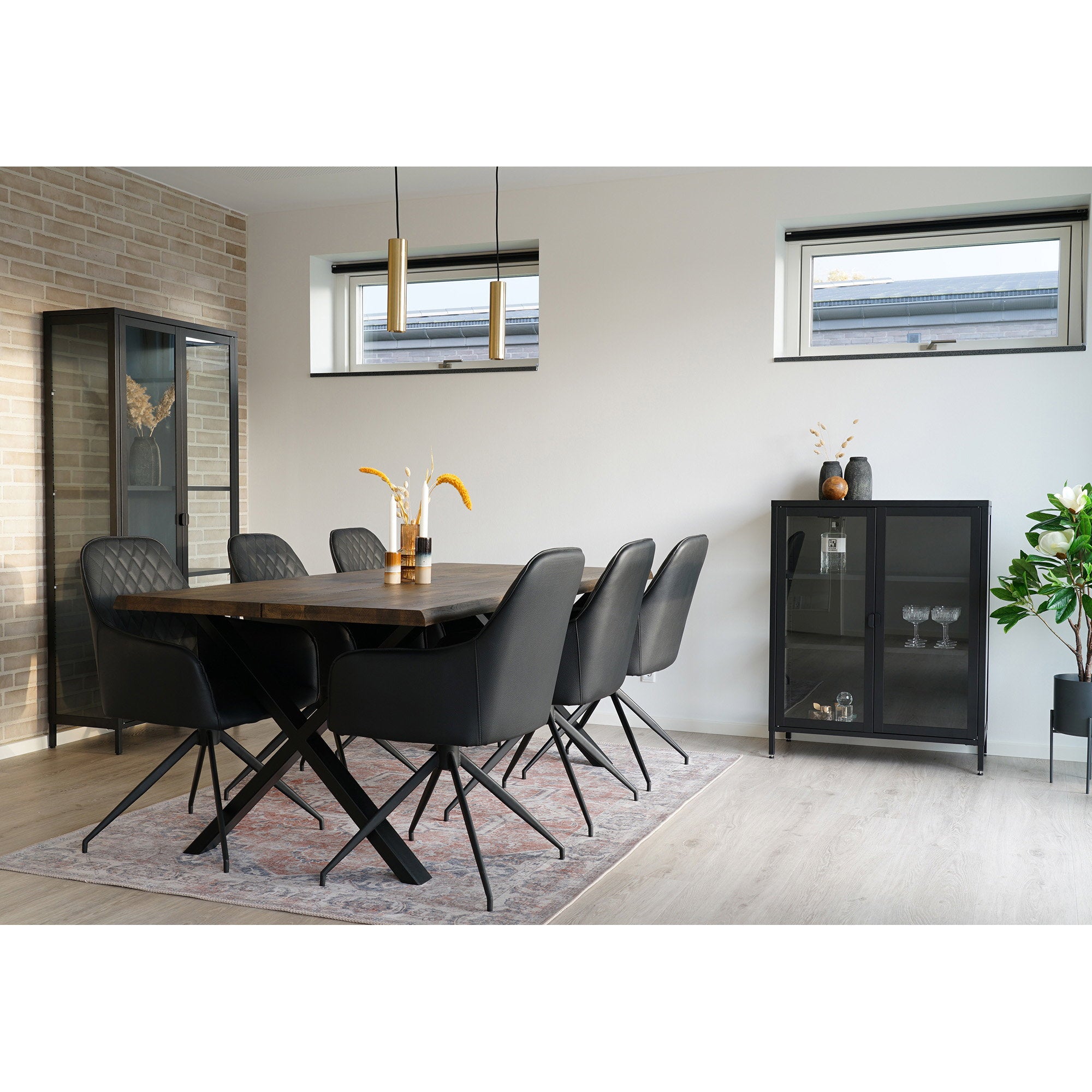 Lot de fauteuils Harbo pivotants simili cuir noir autour table bois avec vitrines noires et suspensions dorées