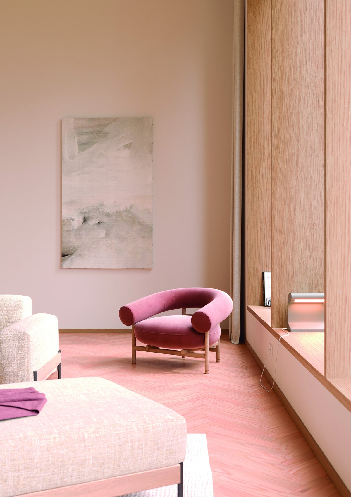 Fauteuil lounge Loop en tissu vieux rose sur structure en chêne naturel, dans un salon aux tons rosés