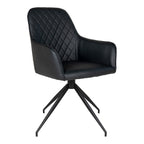 Fauteuil de table Harbo pivotant en simili cuir noir matelassé losanges avec pied étoile acier noir vue trois quarts