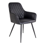 Fauteuil de table Harbo noir en simili cuir matelassé losanges avec pieds acier noir vue trois quarts