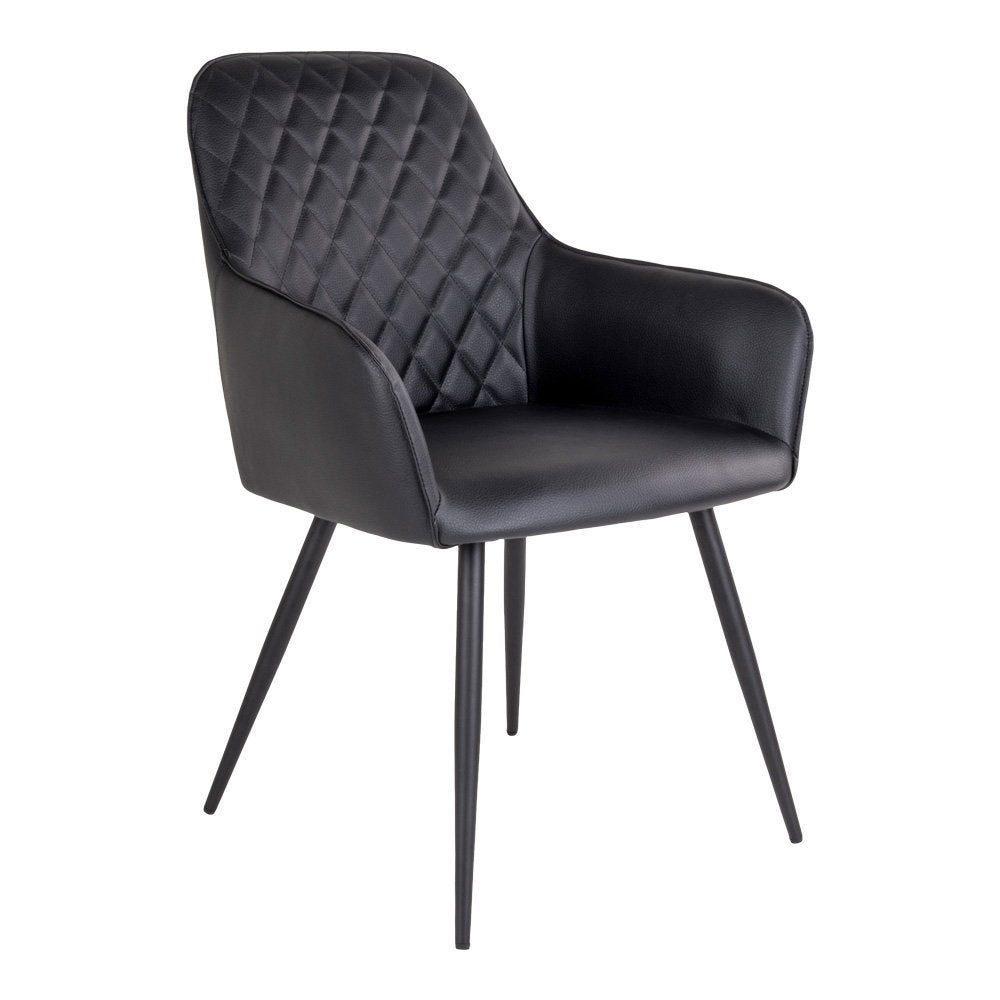 Fauteuil de table Harbo noir en simili cuir matelassé losanges avec pieds acier noir vue trois quarts