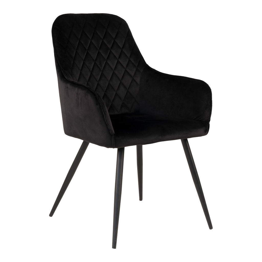 Fauteuil de table Harbo en velours noir matelassé losanges avec pieds acier noir vue trois quarts