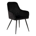 Fauteuil de table Harbo en velours noir matelassé losanges avec pieds acier noir vue trois quarts