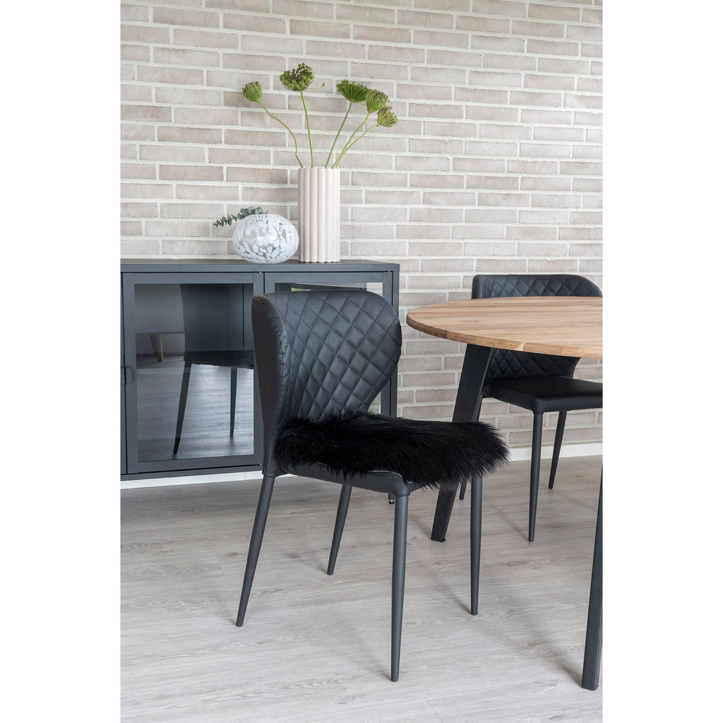 Galette chaise fausse fourrure noir posée chaise cuir noir table ronde bois sideboard anthracite