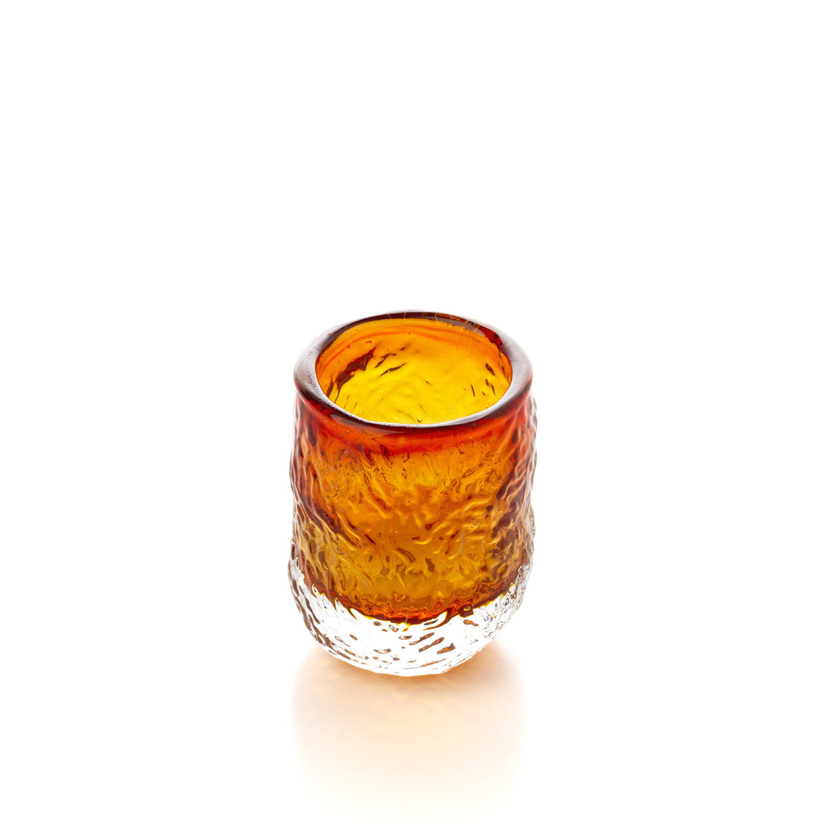 Gobelet en verre ambré dégradé vu de trois quarts qui montre son bord irrégulier et l'intérieur jaune d'or