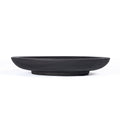 Grande coupe décorative Bowlzilla en bois noirci vue de profil sur son pied annulaire