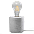 Lampe à poser Salgado en béton brut, cylindre à ampoule apparente, vue de face