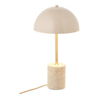Lampe de table Sheffield allumée vue de face lumière rabattue sur le socle en travertin
