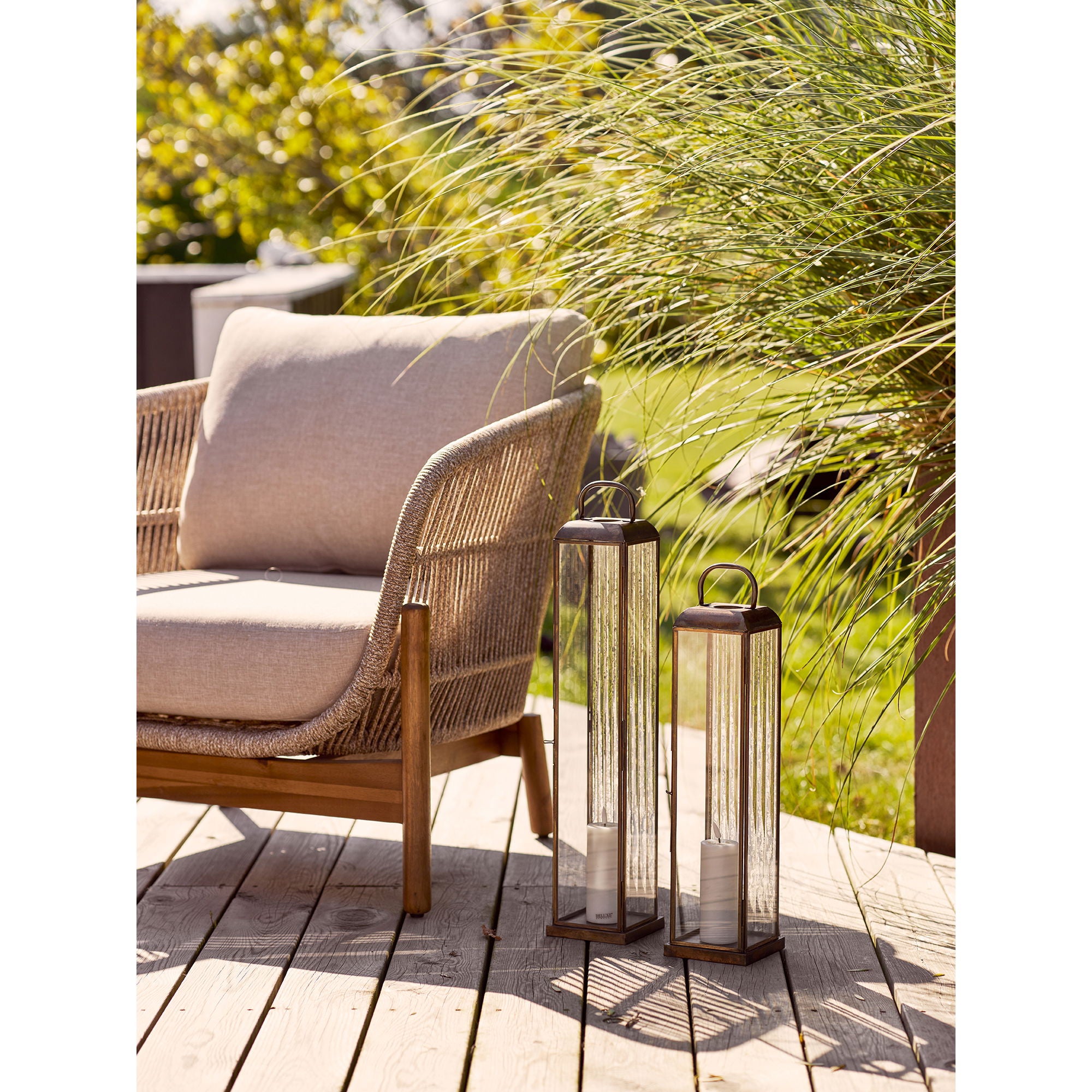 Duo de lanternes photophores Herslev laiton antique sur terrasse avec salon de jardin