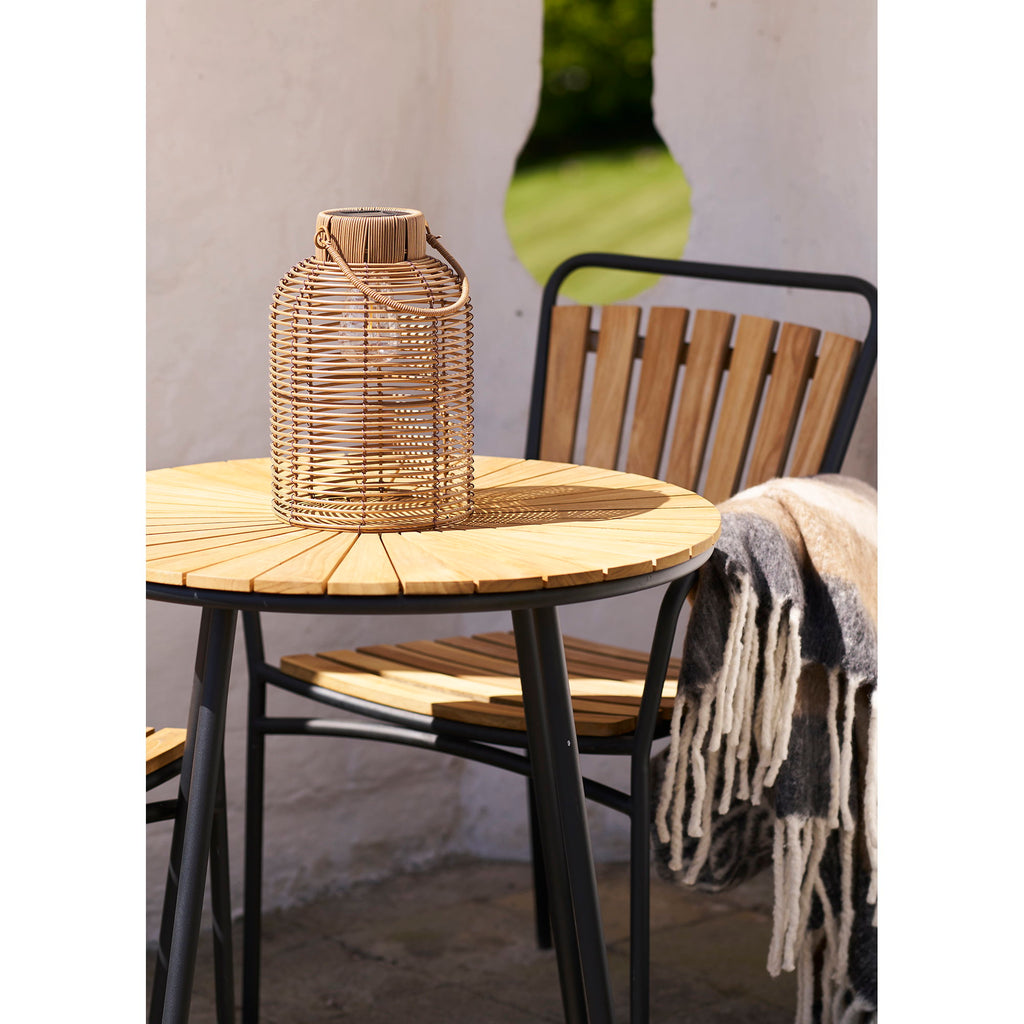 Lanterne solaire Brentford naturelle posée sur table jardin bois, ambiance extérieure cosy