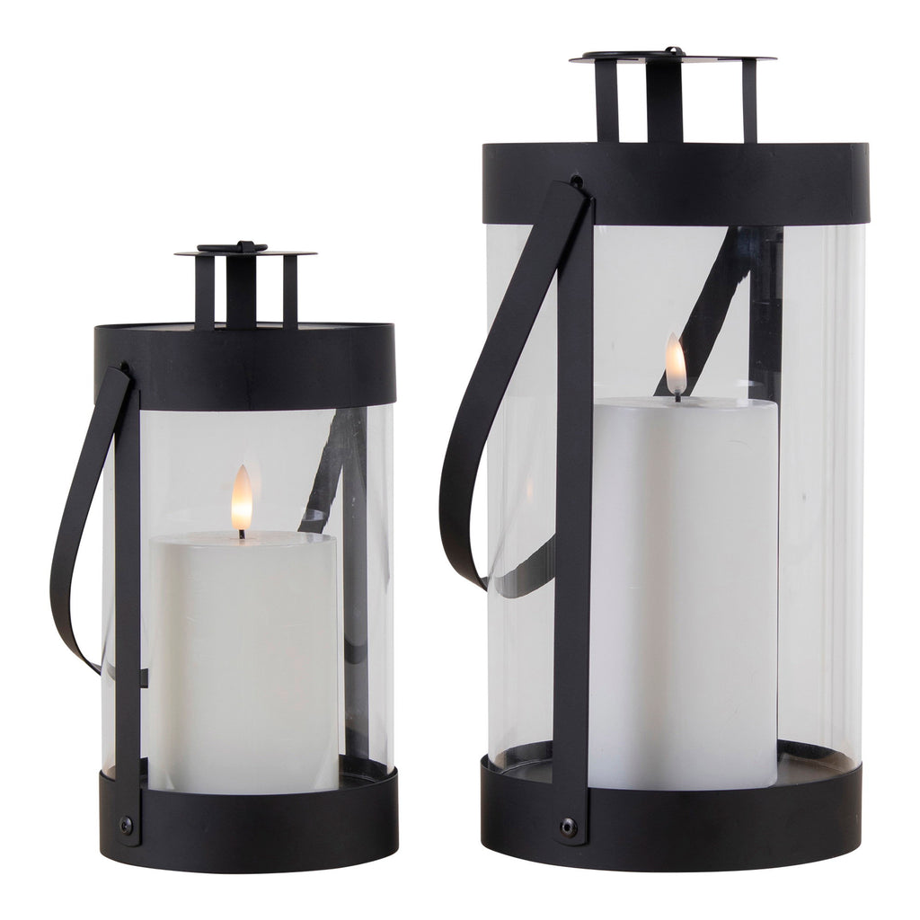 Lot de 2 lanternes Bondi cylindriques noires acier et verre avec bougies allumées, fond blanc
