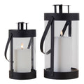Lot de 2 lanternes Bondi cylindriques noires acier et verre avec bougies allumées, fond blanc