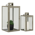 Lot de 2 lanternes Corfu en métal vert kaki et verre transparent, vue trois quarts avec plante et bougie