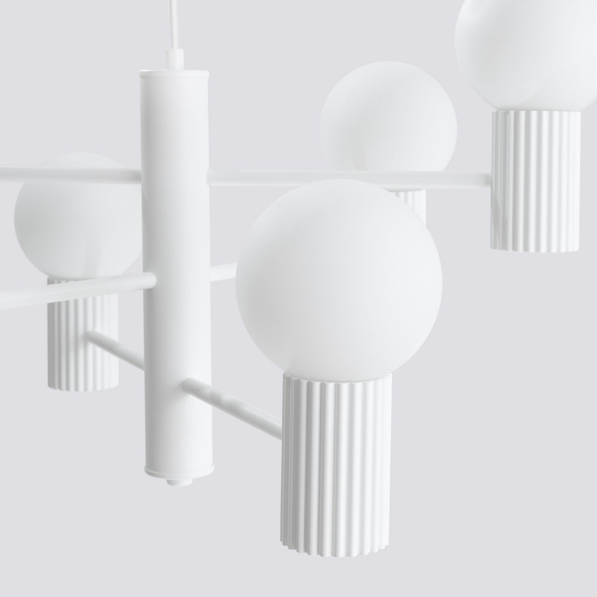 Détail du fût central laque blanche avec ses bras et ses culots cannelés sous les boules opales
