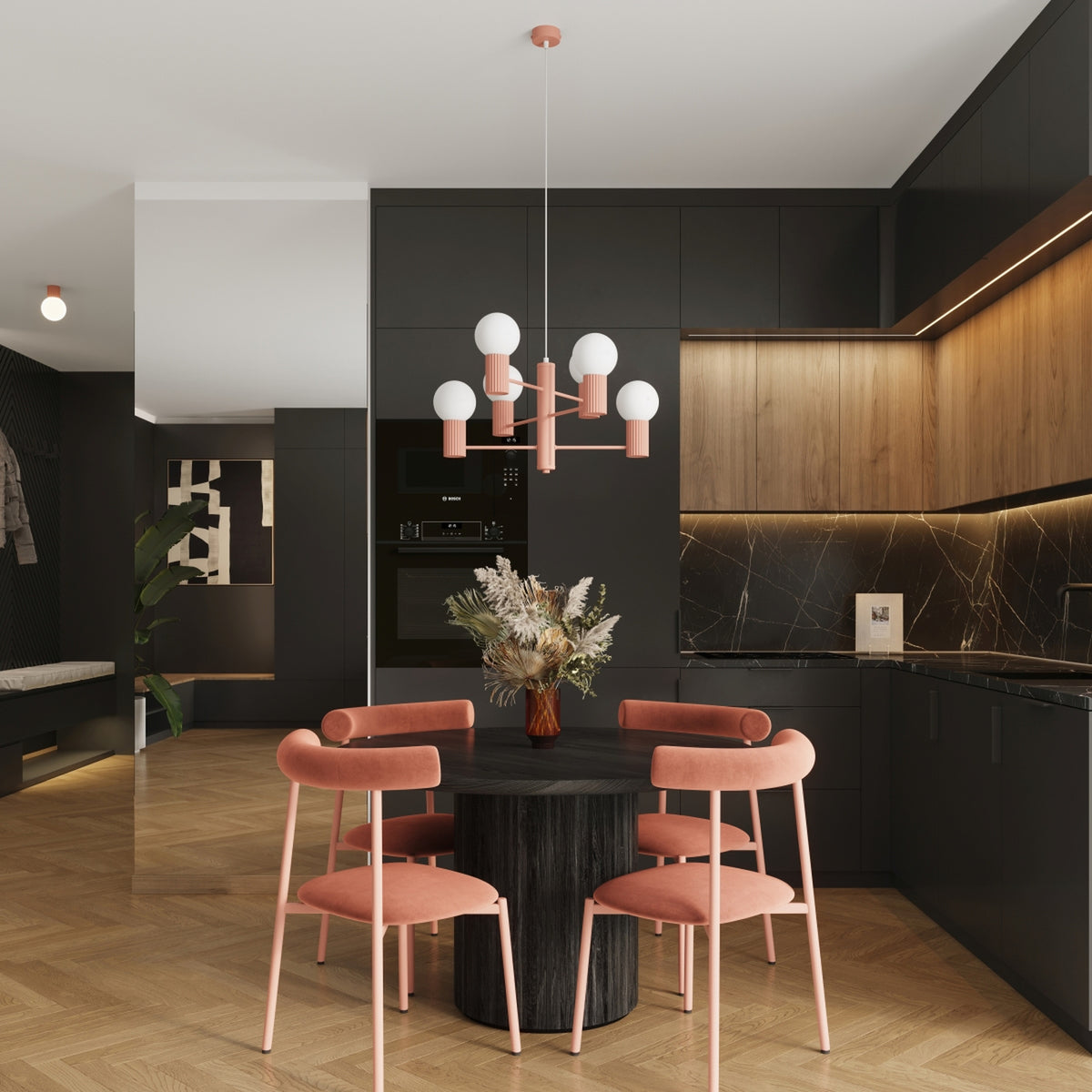 Lustre Halo laque rose pêche au-dessus d'une table ronde en bois sombre entourée de quatre chaises dans une cuisine ouverte