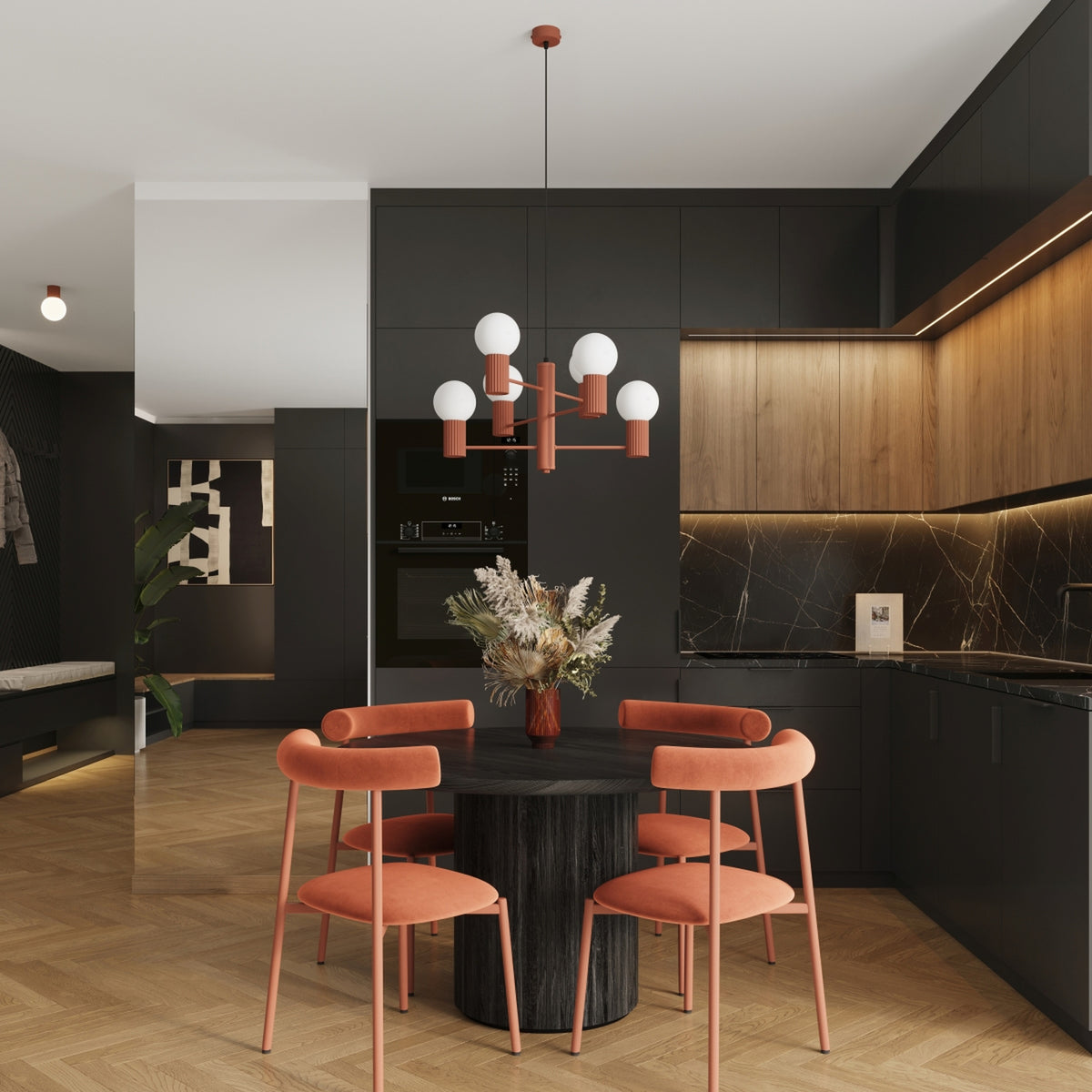 Lustre Halo laque rouge ocre au-dessus d'une table ronde en bois sombre entourée de quatre chaises dans une cuisine ouverte