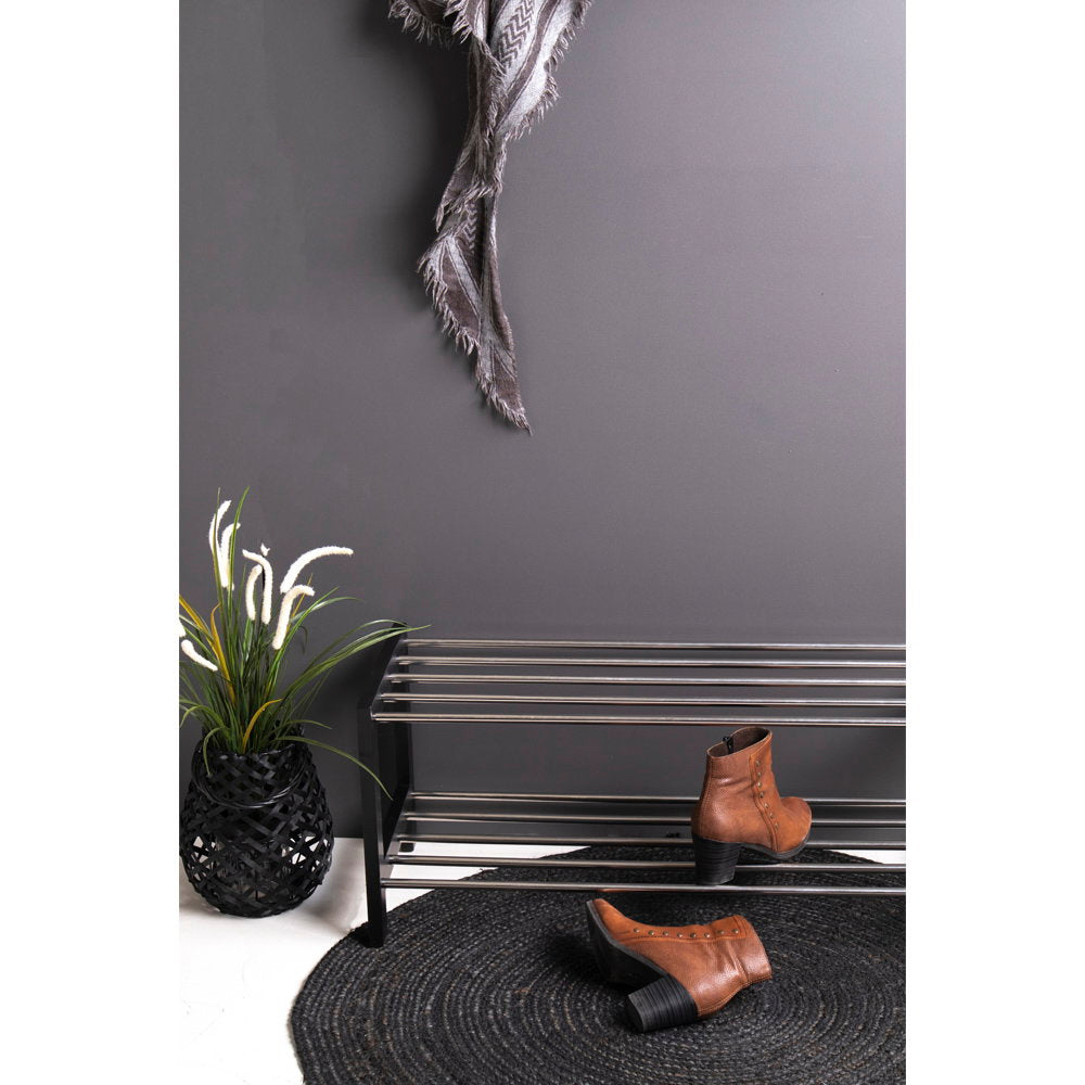 Gros plan meuble chaussures Padova noir barreaux acier avec bottines en situation