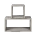 Meuble d'appoint Dice en béton gris naturel avec le petit module empilé sur le grand sur fond blanc