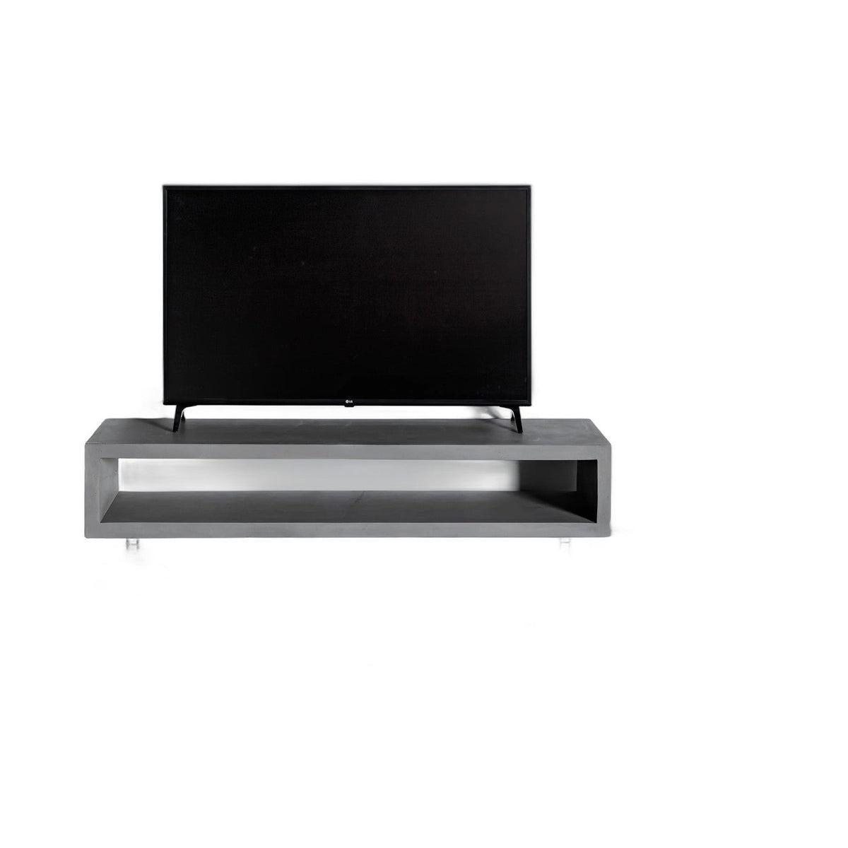 Meuble TV Monobloc en béton gris avec un téléviseur posé dessus et sa niche ouverte