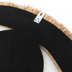 Dos du miroir Raffia Eye habillé de toile noire avec sa patte d'accroche métallique