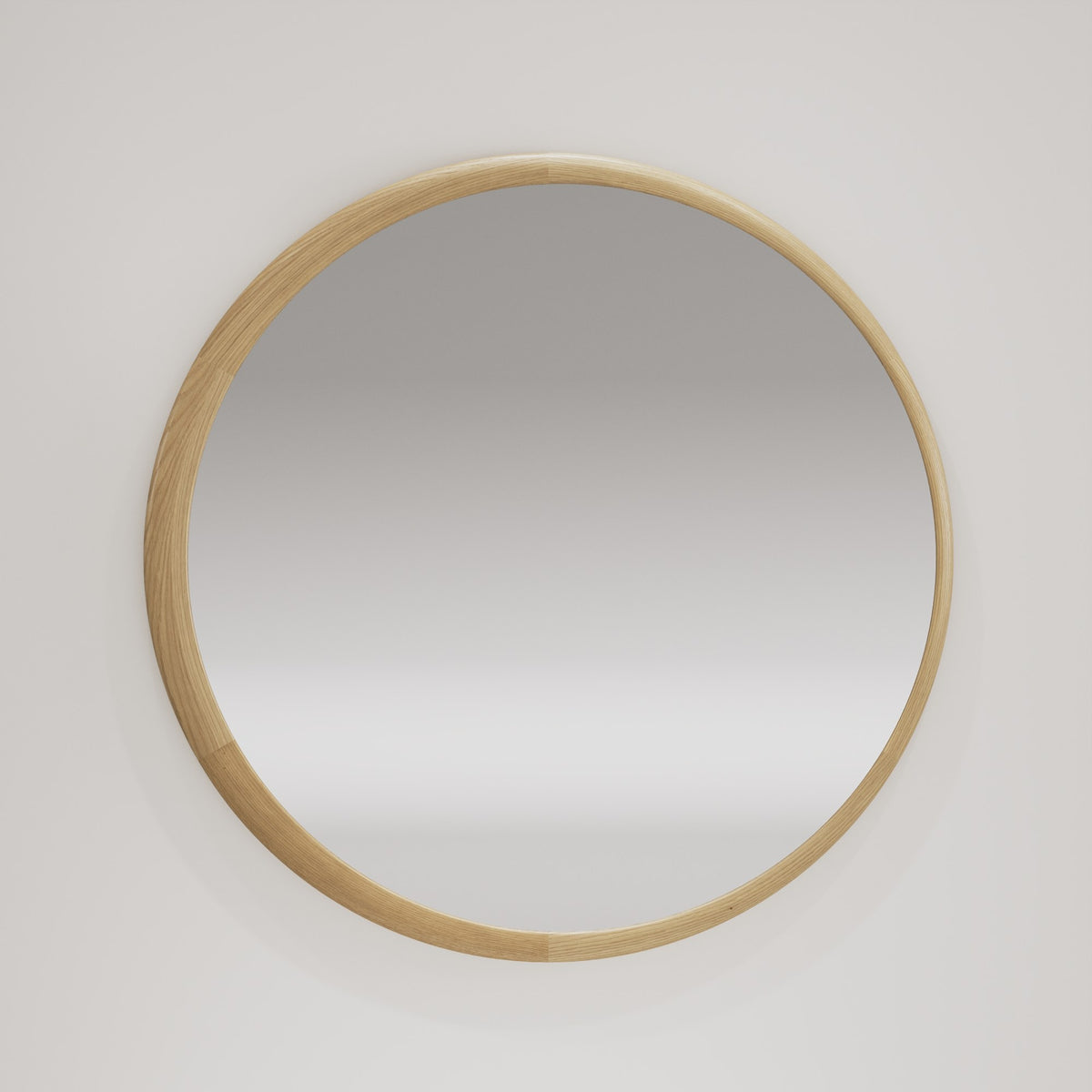 Miroir rond Luna au cadre en chêne naturel accroché au mur