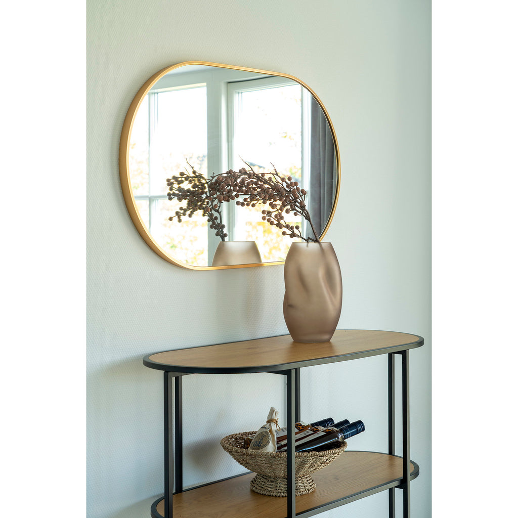 Miroir Madrid cadre laiton doré au-dessus d'une console dans une entrée chic