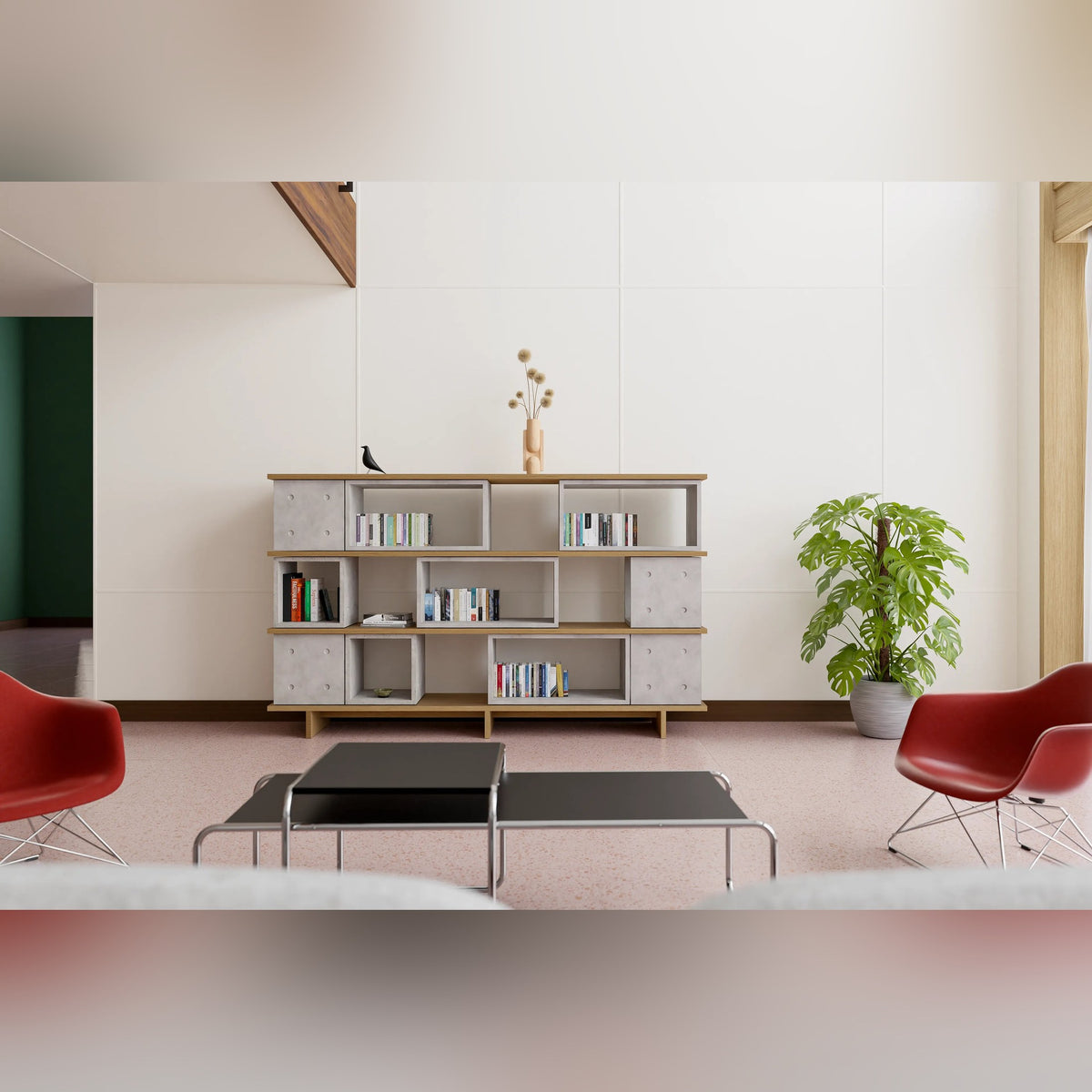 Salon avec une bibliothèque en modules Dice en béton et étagères plaquées chêne face à deux fauteuils rouges