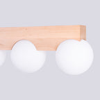Détail des globes en verre blanc logés dans les encoches arrondies de la barre en bois du plafonnier Bulbo 3