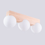 Plafonnier Bulbo 3 vu de trois quarts avec sa barre en bois naturel et ses trois globes blancs