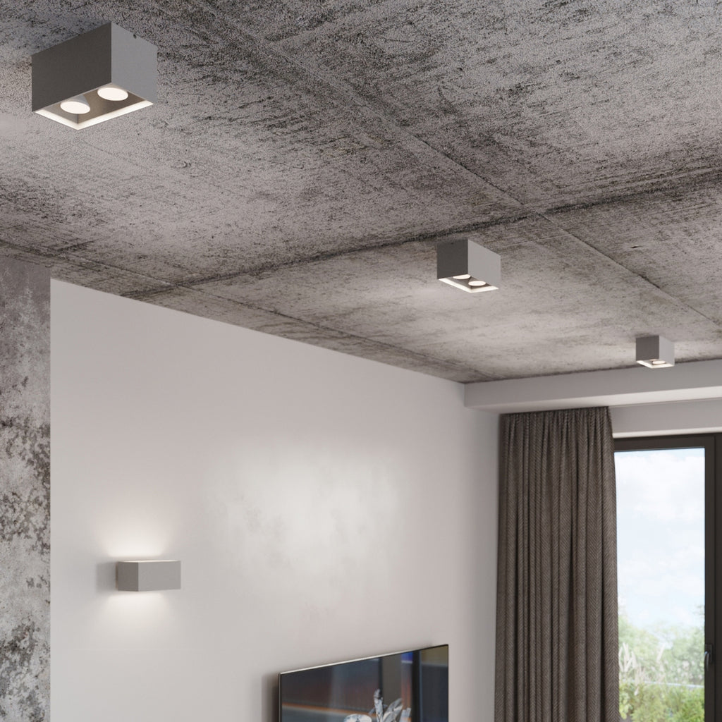 Plafonnier Quad Maxi gris éclairant une pièce contemporaine