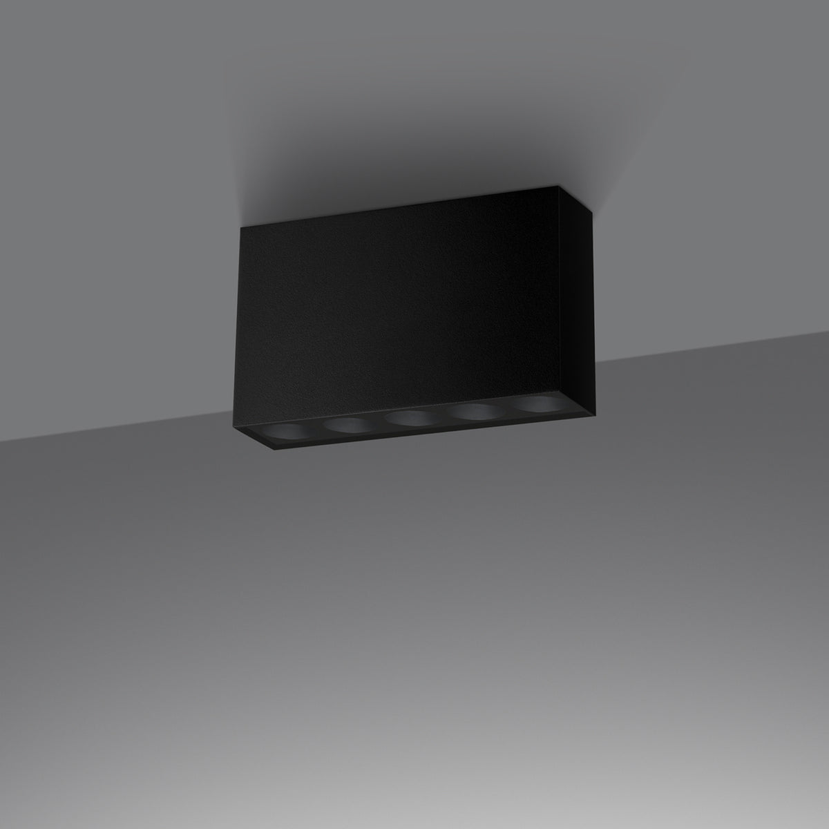 Plafonnier Sole noir posé au ras d'un plafond gris vu en contre-plongée