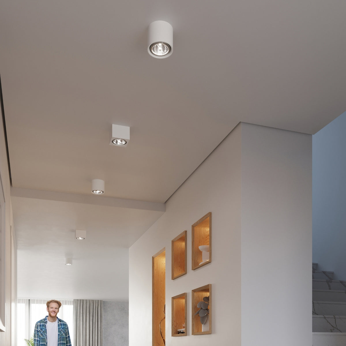 Plafonniers Kalu cylindriques allumés au plafond d'un couloir clair