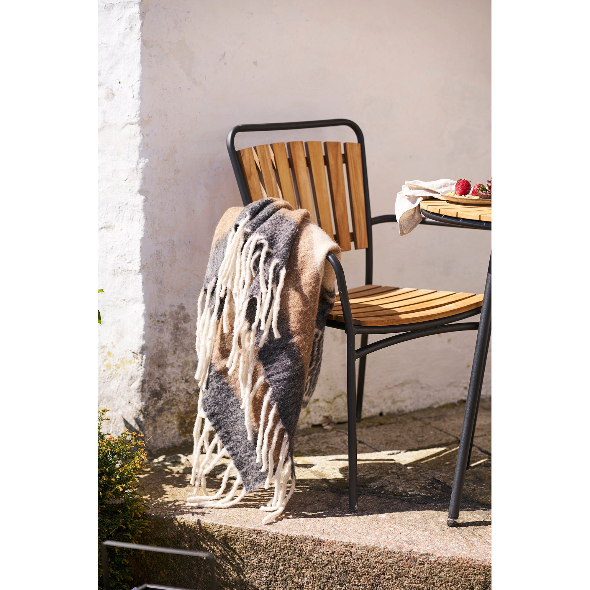 Plaid Carmel laine rayé multicolore drapé sur chaise jardin métal bois ambiance nordique