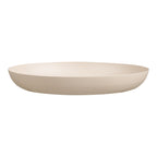 Plateau rond en métal beige vu de profil avec son fond plus étroit et sa paroi arrondie jusqu'au bord
