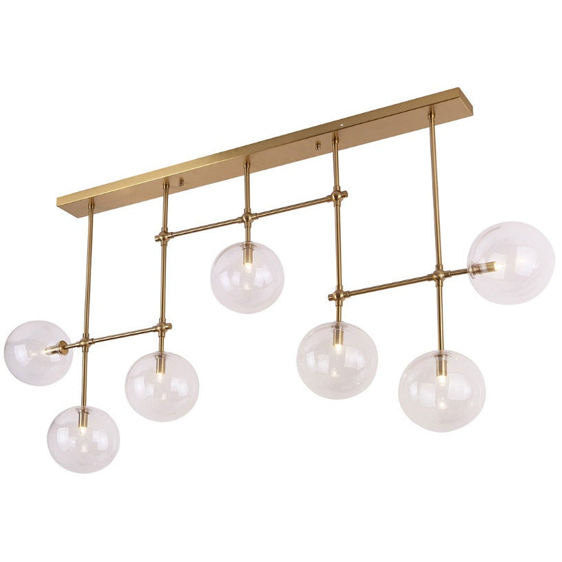 Suspension linéaire Lollipop finition laiton à sept globes de verre transparent sur tiges fixées à une longue platine