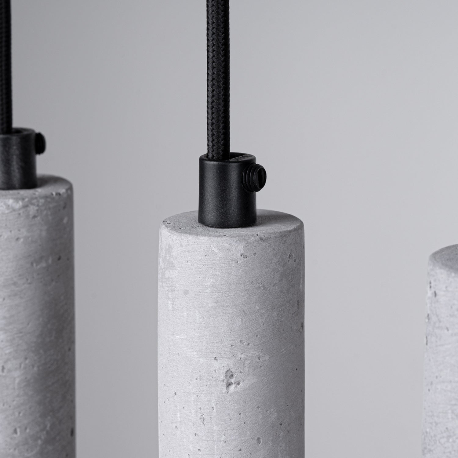 Suspension Pastelo 5 en ligne tubes fins béton gris G9, détail du béton gris brut