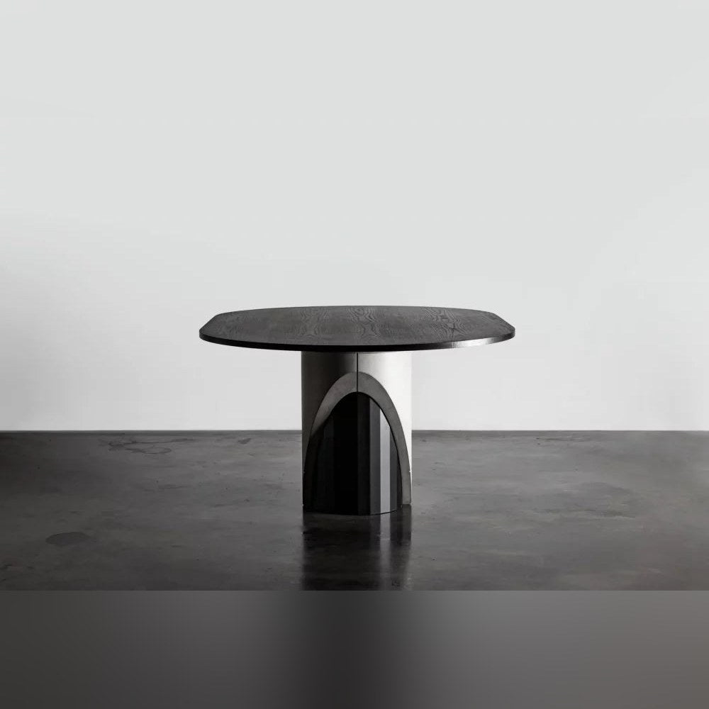 Table à manger Sharp oblongue vue de face avec son lest en béton en arche sur un sol en béton sombre